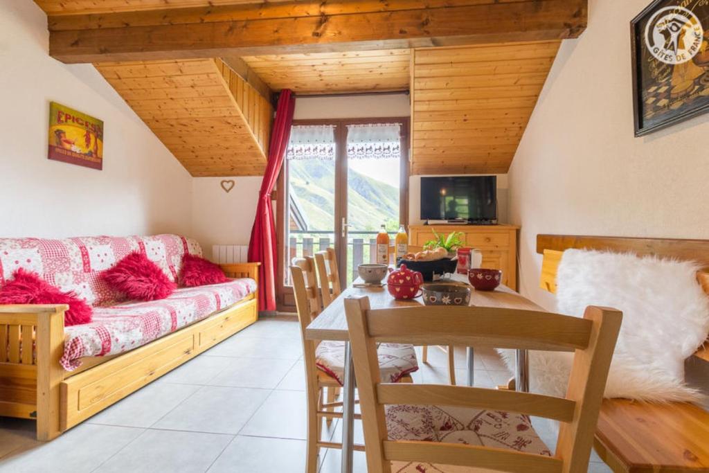 a living room with a couch and a table at Les Balcons de St So Appartement B in Saint-Sorlin-dʼArves