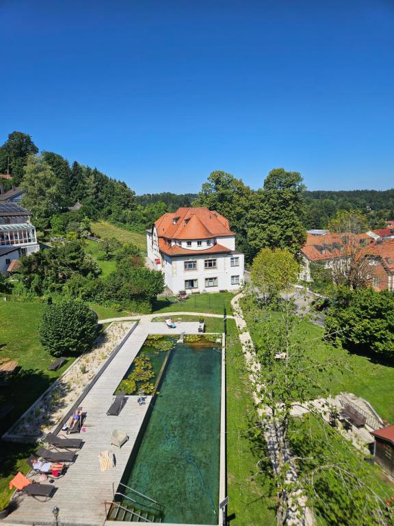 an aerial view of a swimming pool in front of a house at Villa am Park in Bad Tölz