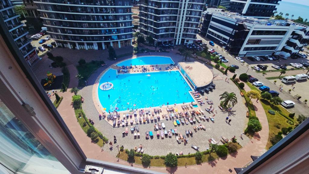 an overhead view of a swimming pool in a city at Top Beachfront Apartment in Batumi