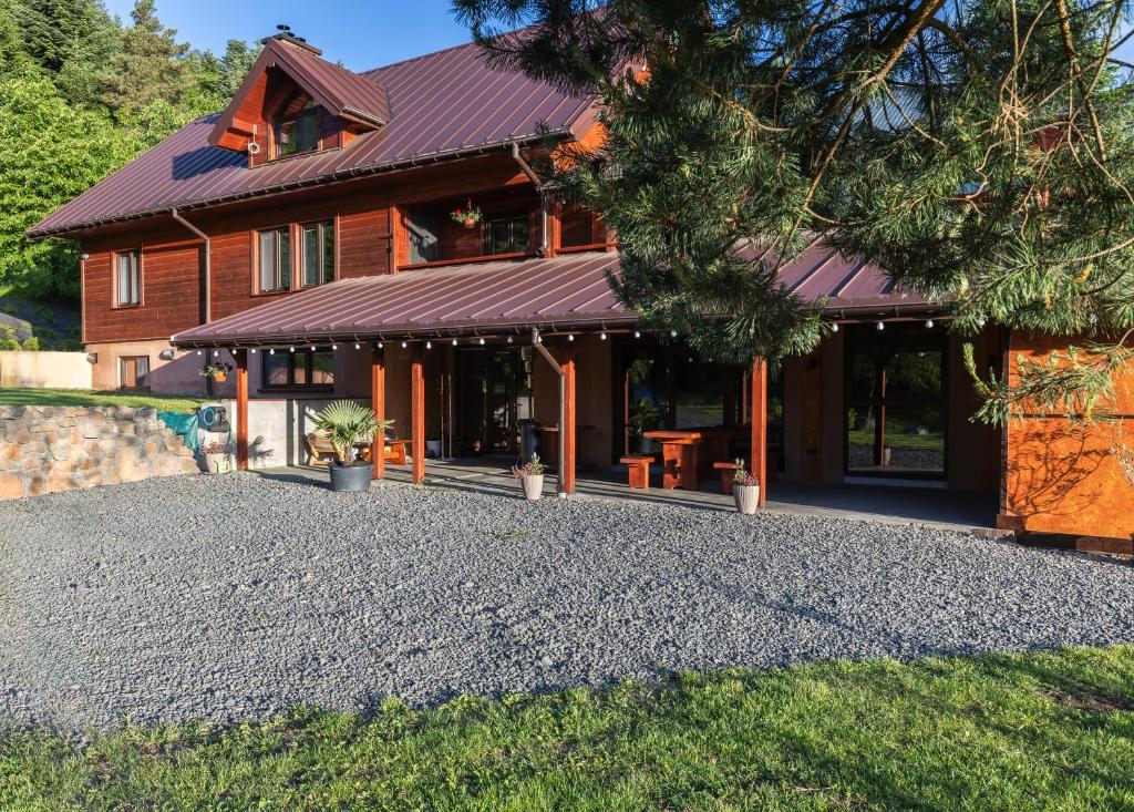 a house with a gravel driveway in front of it at Dom Gościnny Nasza Góra in Szymbark