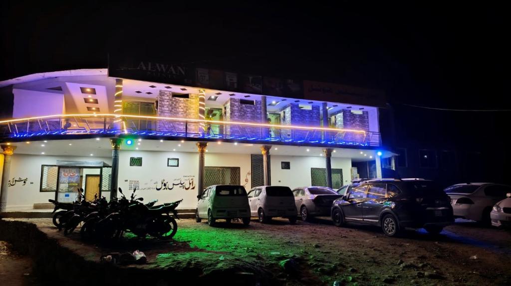 a building with cars parked in front of it at night at Royal Palace in Naran