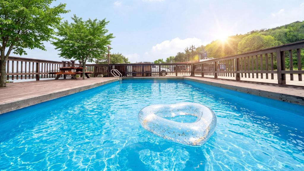 a swimming pool with a raft in the water at Daebudo Sketch Pension in Ansan