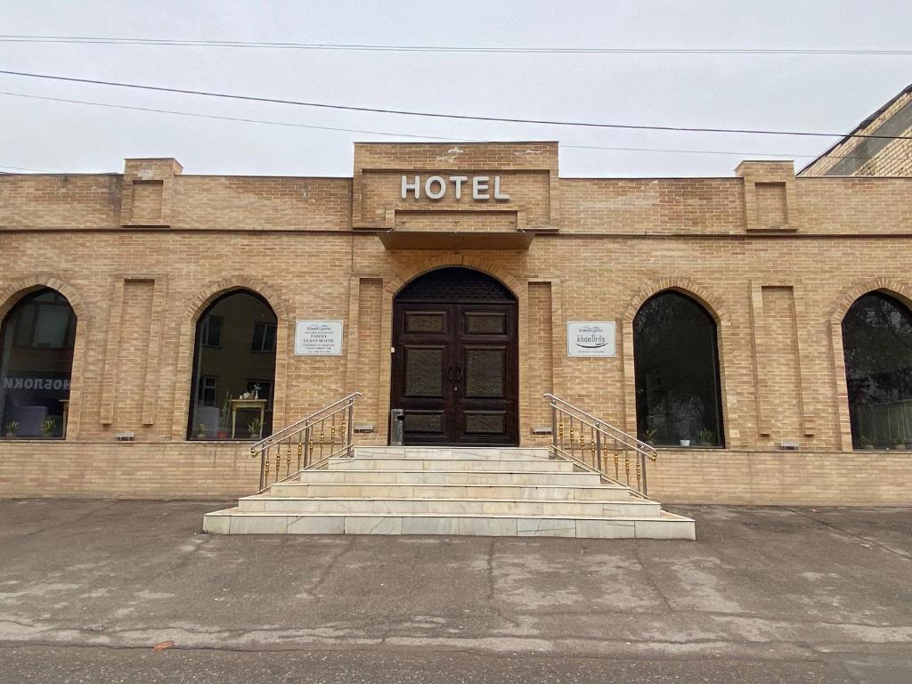 a hotel building with stairs in front of it at Orda Hotel in Yunusobod