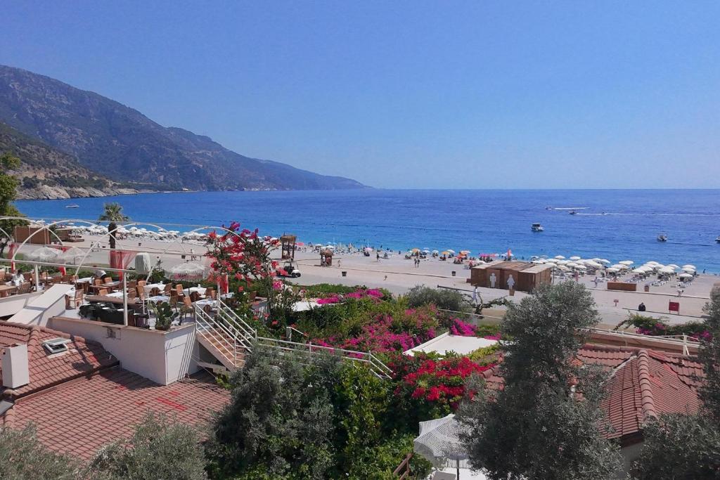 a view of a beach with umbrellas and the ocean at Oyster Residences - Adult Only in Oludeniz