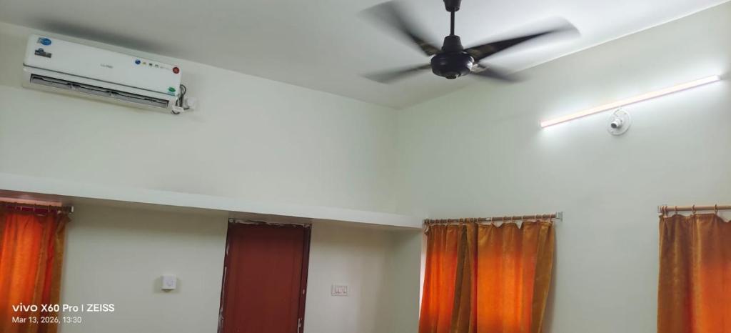 a ceiling fan in a room with curtains at Mayurbhanj Stay Inn in Baripāda