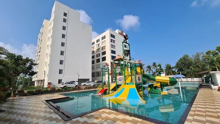 a swimming pool with a water park with a slide at Shore Appartments in Udupi
