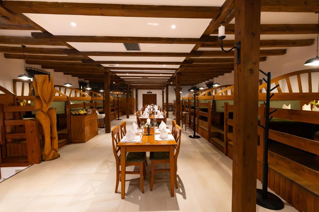 a dining room with wooden tables and chairs at Hotel Selsky Dvur in Vyškov