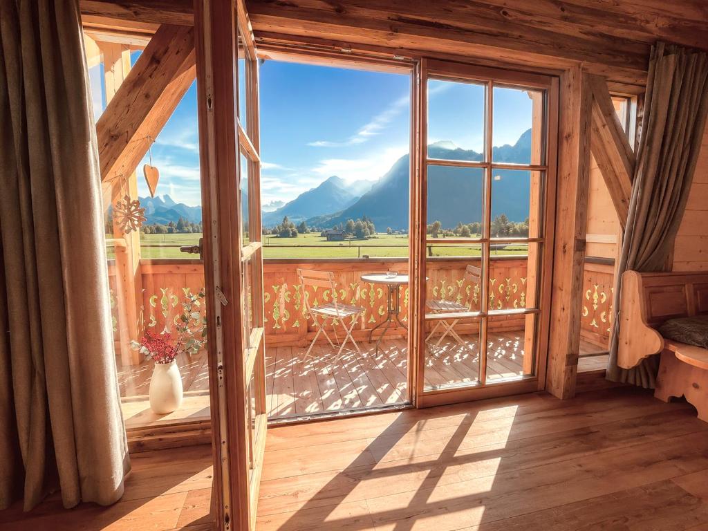 a room with a large window with a view of the mountains at Chalet Herbst in Lofer