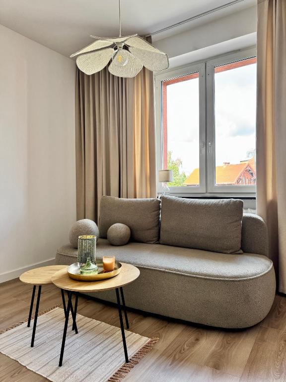 a living room with a couch and a table at Kaszmir Studio in Tarnowskie Góry