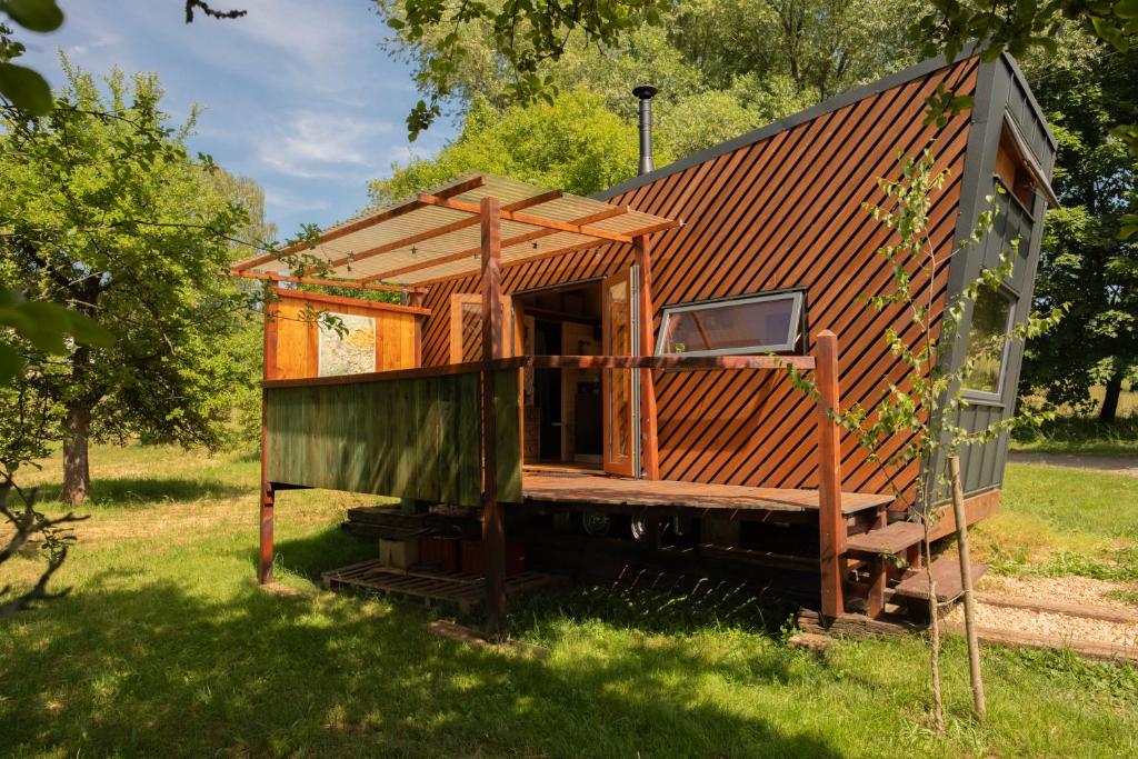 a small wooden house in a field of grass at Ráj pod Troskami in Semily