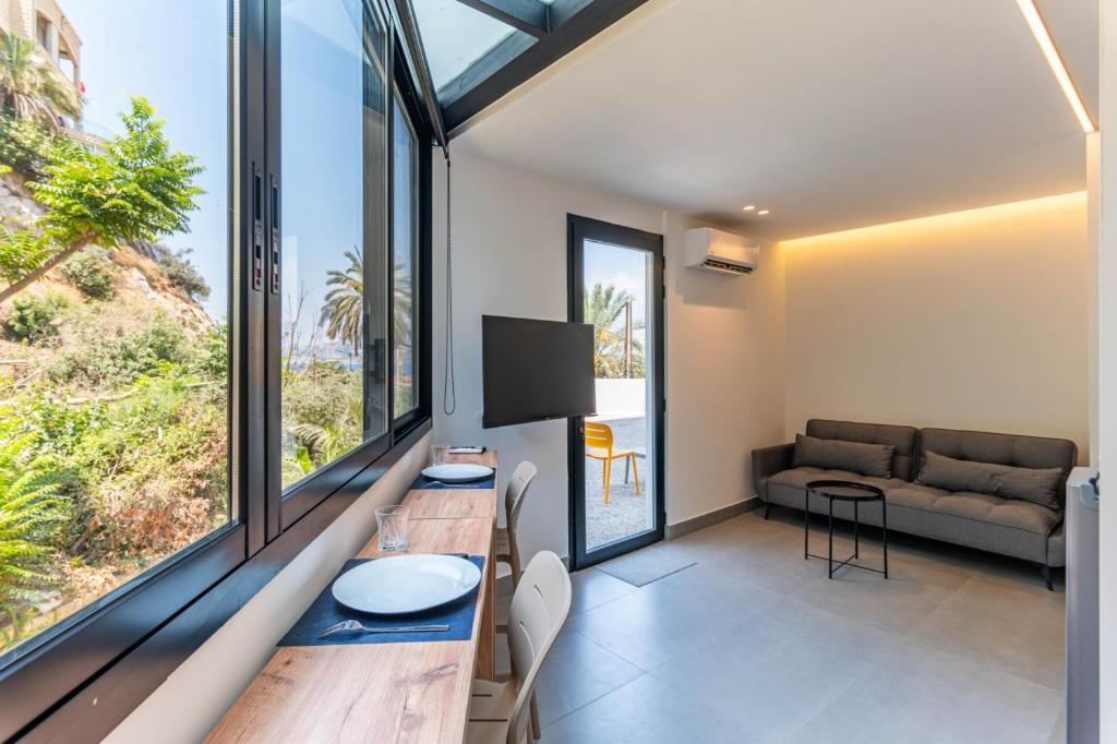 a living room with a table and a couch at Les Jardins Kaslik in Al Bāţiyah