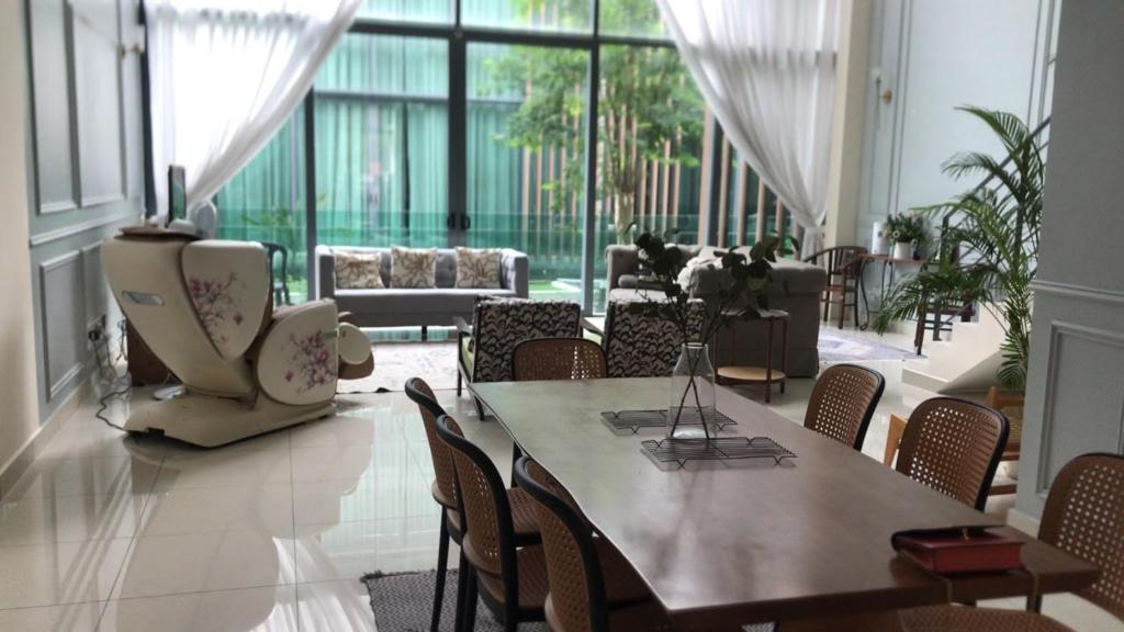 a large room with a table and chairs in a building at Luxury, Affordable and Spacious Private Villa with Swimming Pool & Jacuzzi for 20 plus ppl Cyberjaya in Cyberjaya