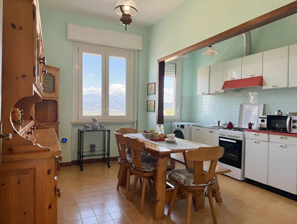 a kitchen with a wooden table and chairs in it at La Casa dell'Anello - Relax & View - ItalyWeGo in Narni