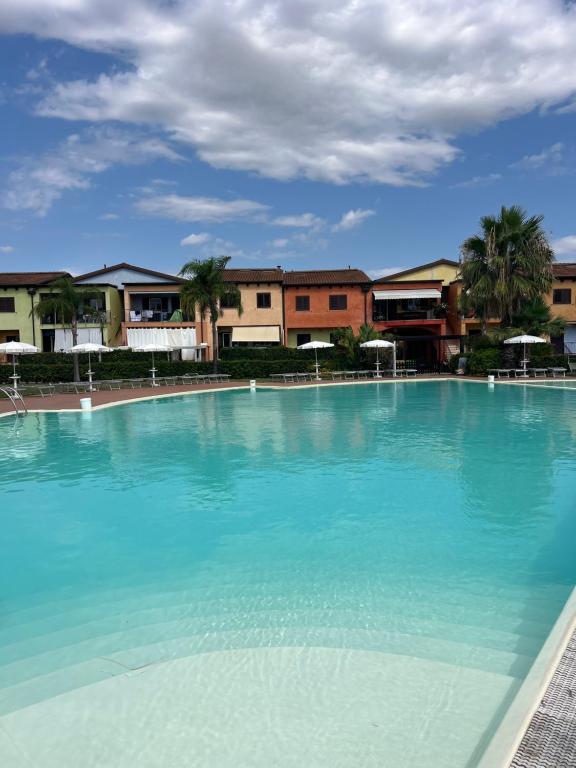 a large pool of blue water with buildings in the background at Dimora sul mare in Policoro