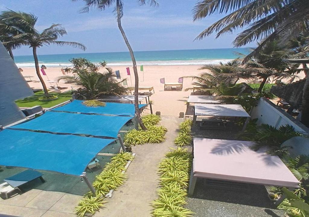 a view of the beach from the balcony of a resort at Josan Villa with a Glorious Beach and Sea View in Habaraduwa Central