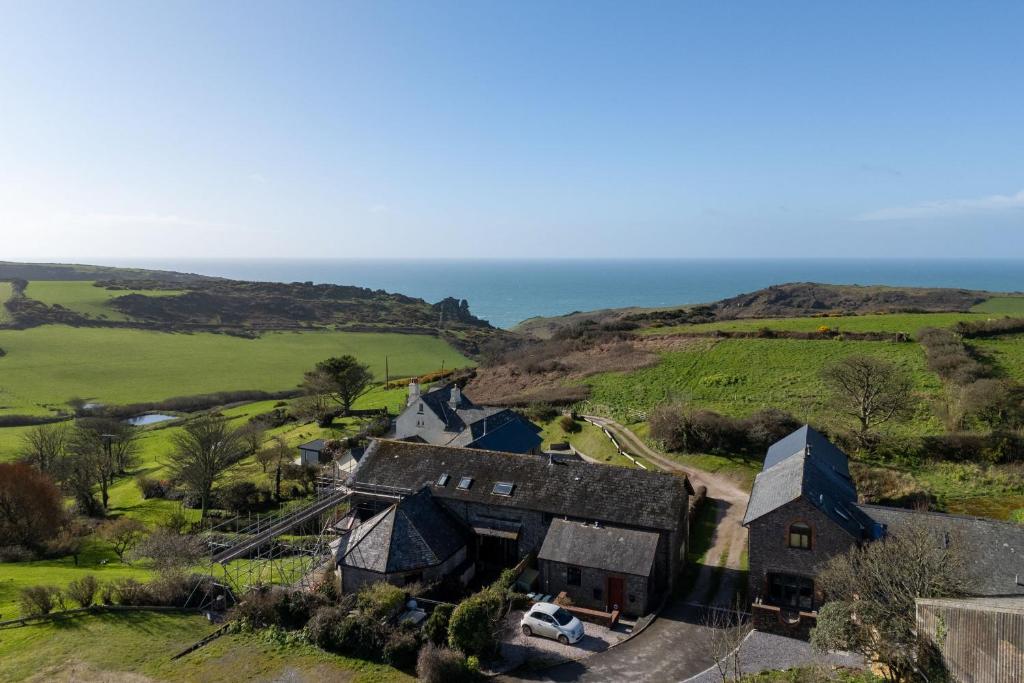 an aerial view of a house with the ocean in the background at The Store in Salcombe