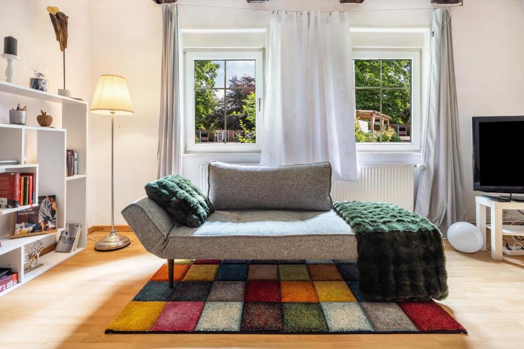 a living room with a couch and a window at Fuchsrevier Fox District Apartment in Erkerode