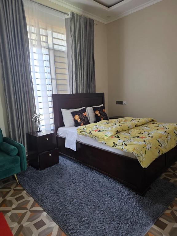 a bedroom with a bed and a window at VC Heritage Residences in Dodoma