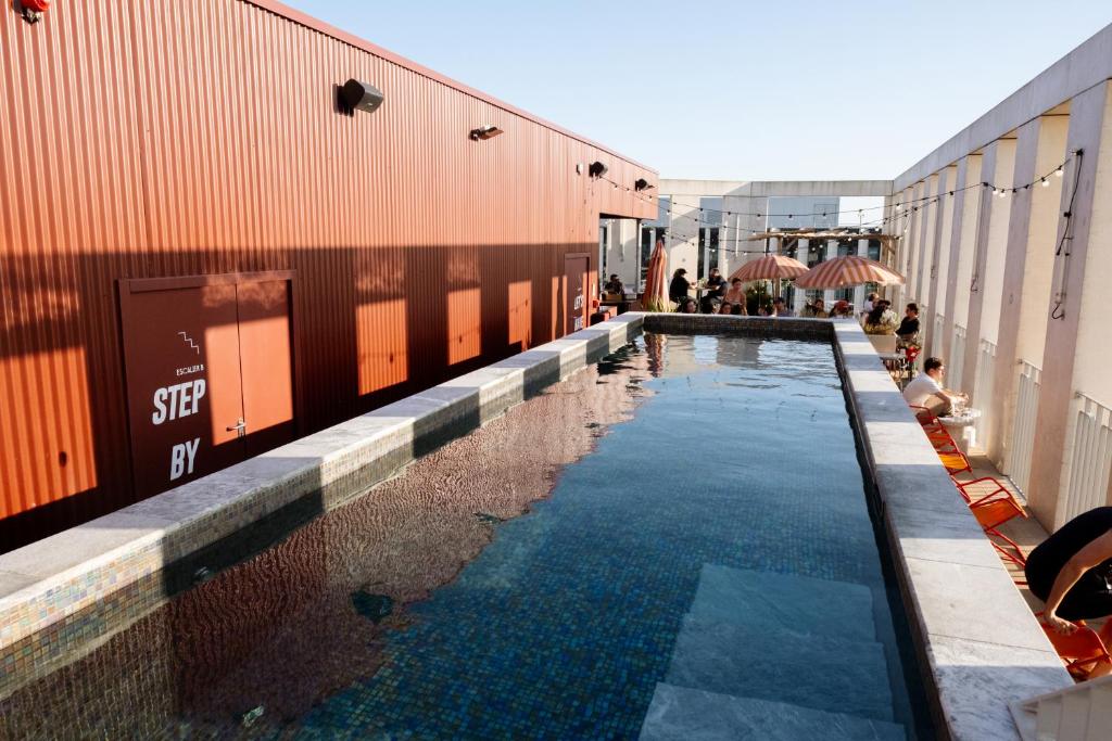 a swimming pool next to a shipping container at JOST Hôtel Bordeaux Centre Gare Saint Jean in Bordeaux