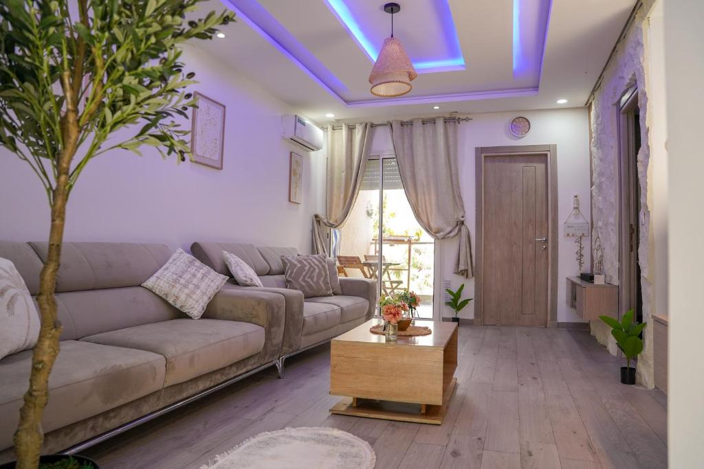 a living room with a couch and a table at Modern Hammamet Stay Pool & Beach in Hammamet Sud