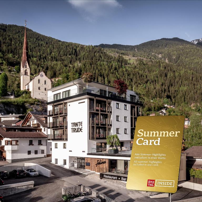 a building with a summer card sign in front of it at Aparthotel Tante Trude - Rooms & Apartments, Ötz in Oetz