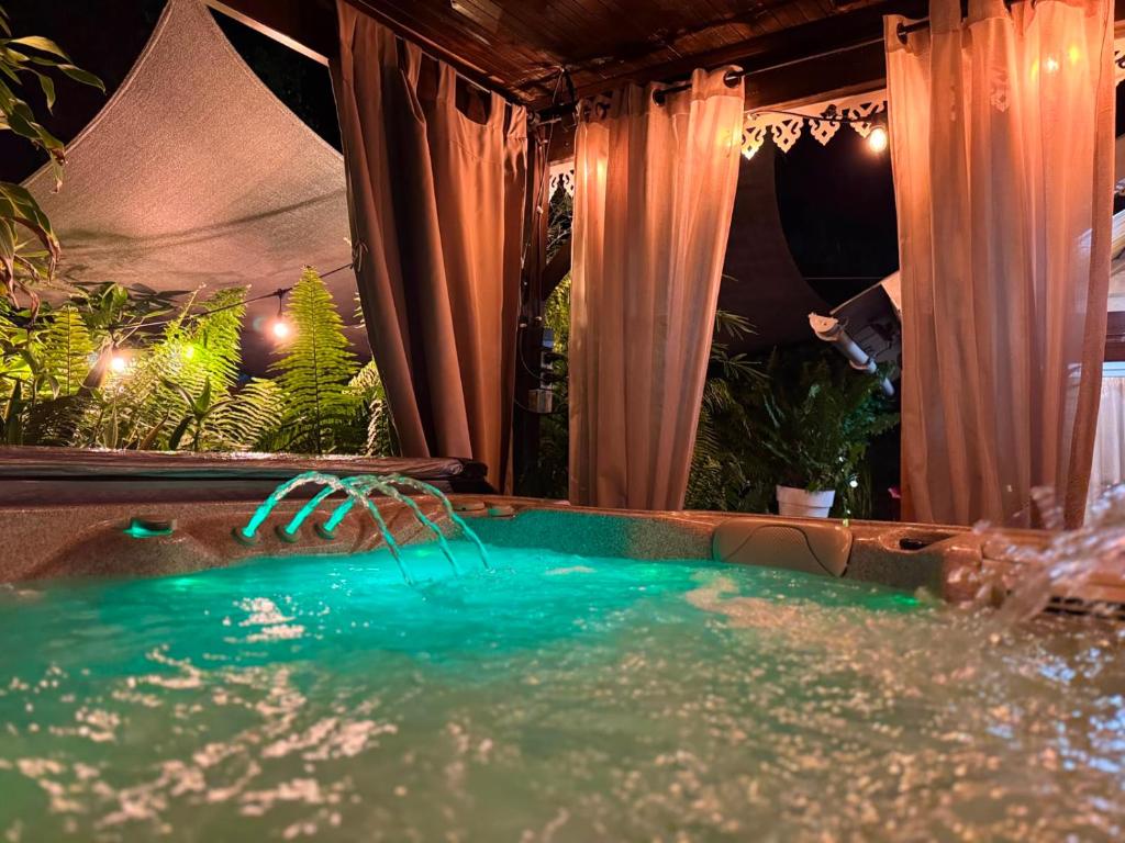a swimming pool in a backyard at night at Le Chalet Atypique in Saint-Pierre
