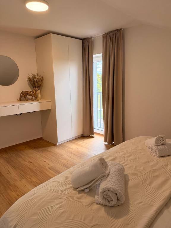 a bedroom with a bed with towels on it at Apartma Julia in Semič