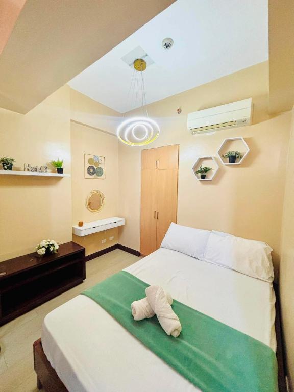a bedroom with a bed with a towel on it at Condo in Mactan Newtown in Lapu Lapu City