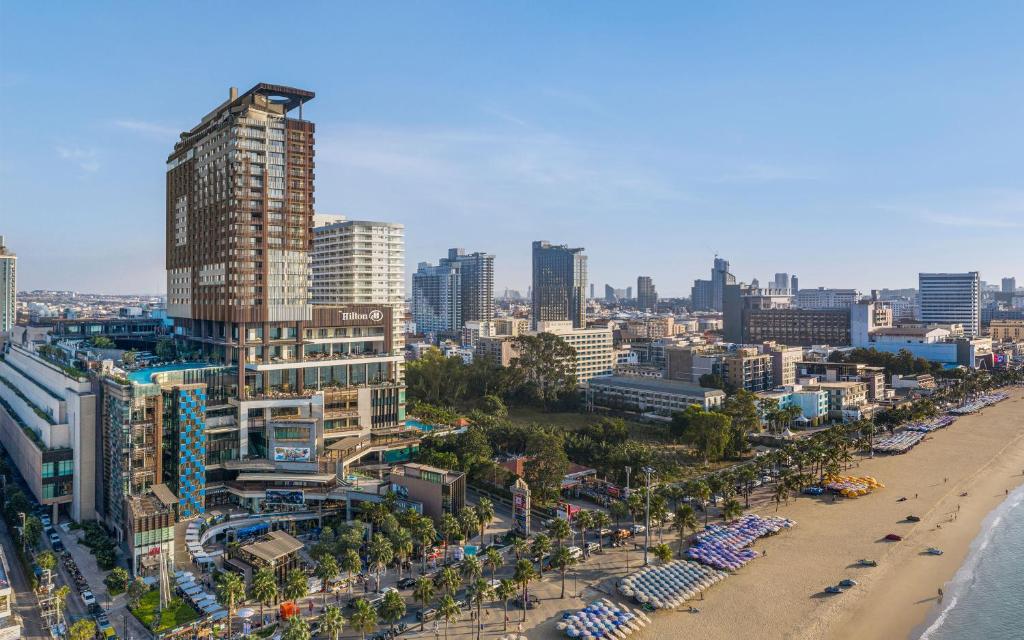 a view of a city with a beach and buildings at Hilton Pattaya in Pattaya