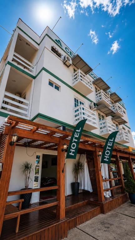 a white building with green signs on it at Hotel Centro dos Canyons in Praia Grande