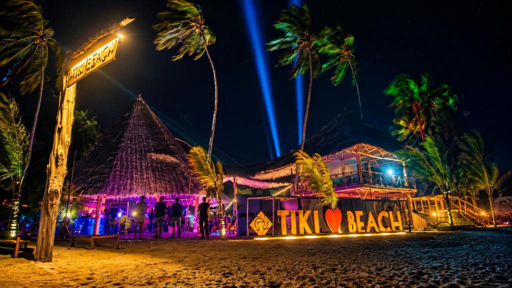 a nightclub on the beach at night at Tiki Beach Economy in Paje