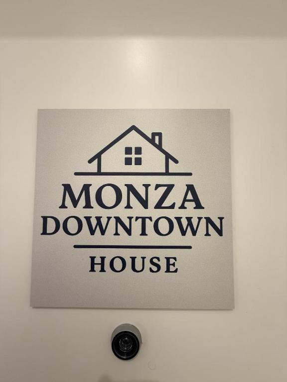 a sign for aomonza downtown house on a wall at Monza Downtown House Via Bartolomeo Zucchi 5 Monza in Monza