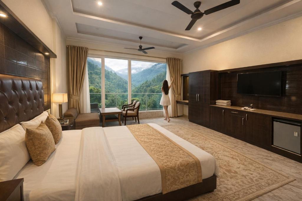 a hotel room with a bed and a large window at The Spring Dale Resort, Mussoorie by Sitara group - Best Selling Resort in Mussoorie 2025-26 in Mussoorie