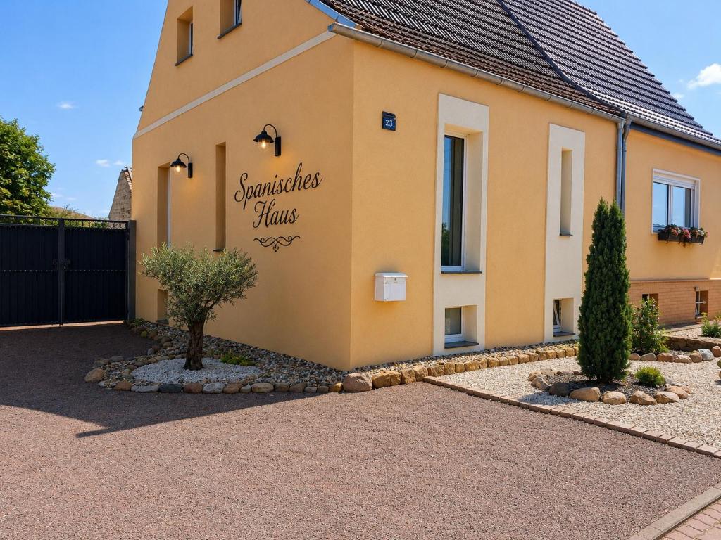 a house with a sign on the side of it at Spanisches Haus in Staßfurt