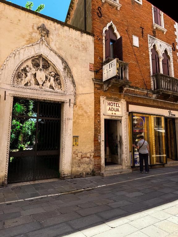 a person standing in front of a building at Hotel Adua in Venice