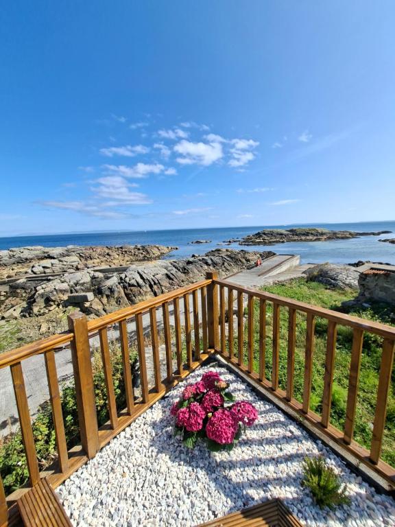 a bunch of pink flowers sitting on a balcony at The Point by the Sea in Carraroe