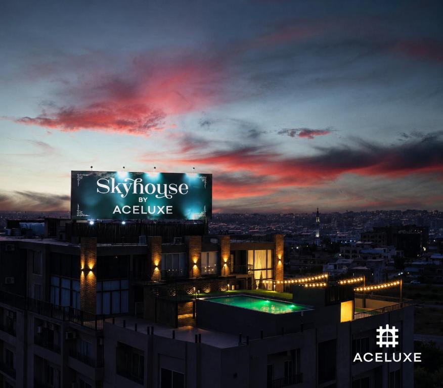 a sign on top of a building at night at SkyHouse by Ace Luxe in Islamabad