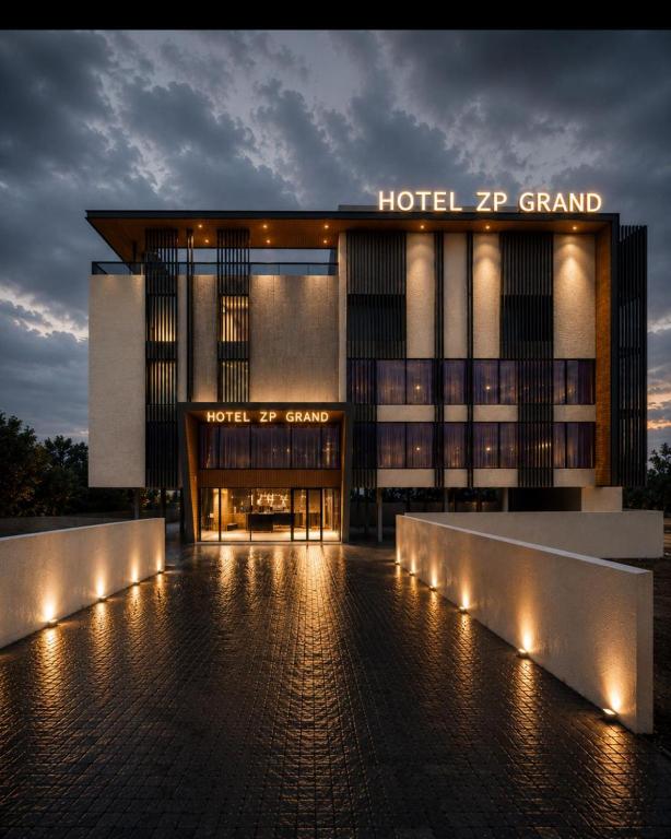 a hotel front with lights in front of a building at Hotel ZP Grand in Bhilai