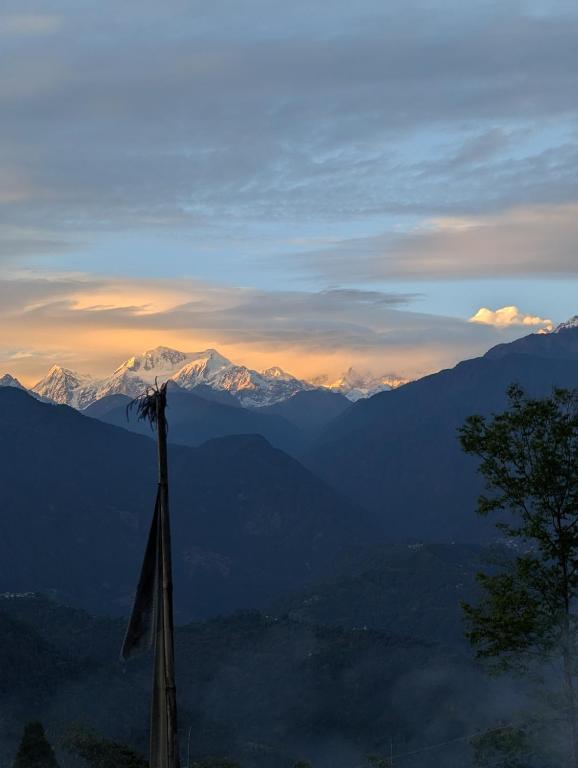 a view of a mountain range with a pole at Mochilero Homestead in Pelling