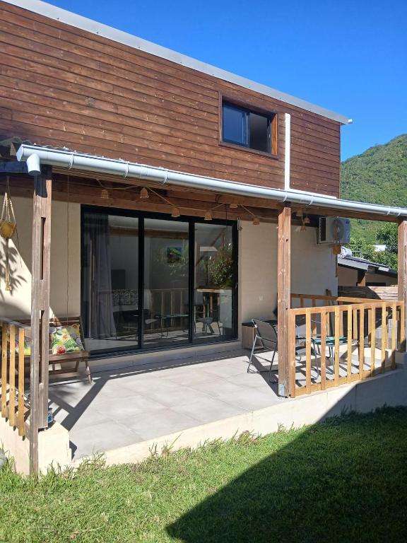 a house with a deck and a patio at Bungalow P&P in Entre-Deux