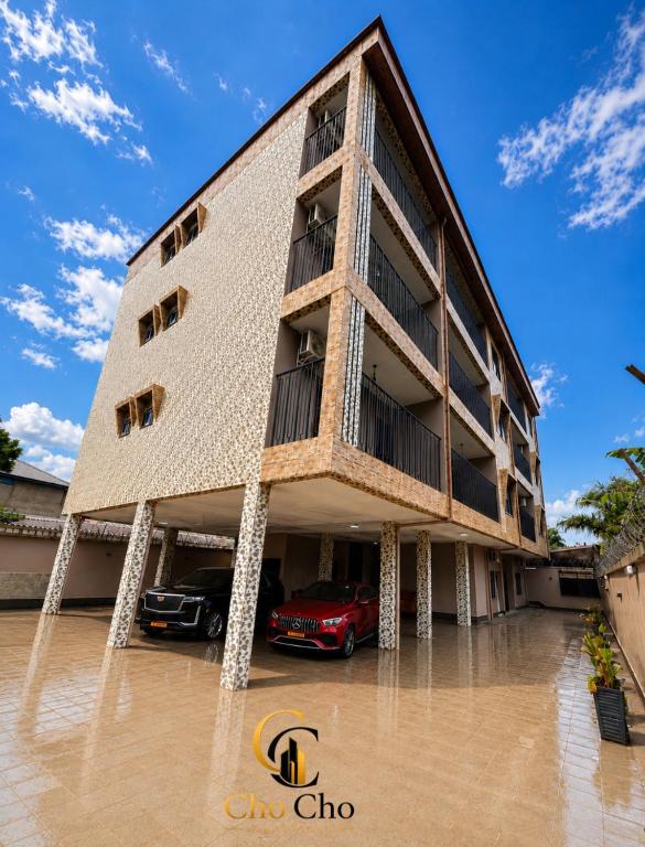 a building with a car parked in front of it at ChoCho Apartments in Limbe