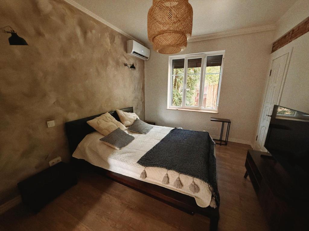 a bedroom with a bed and a window at Portside studio, free parking, self check-in in Klaipėda