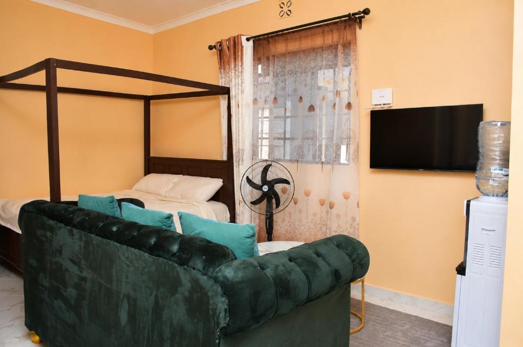 a living room with a couch and a bed at Maria Villa Studio in Voi