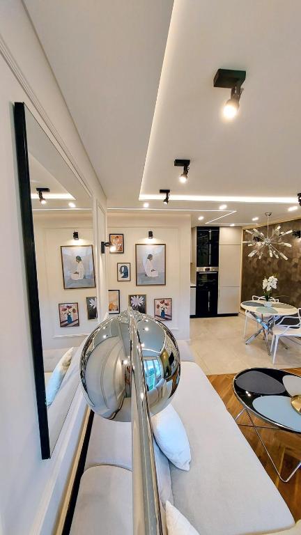 a large living room with a table and chairs at THE ONE Apartment in Tomaszów Mazowiecki