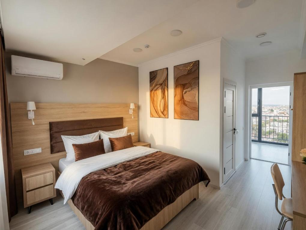 a bedroom with a large bed and a window at Art Moderno Hotel in Tashkent