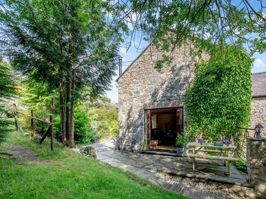 a stone cottage with a bench in front of it at Lavender Cottage - Ukc6677 in Bettws-yn-Rhôs