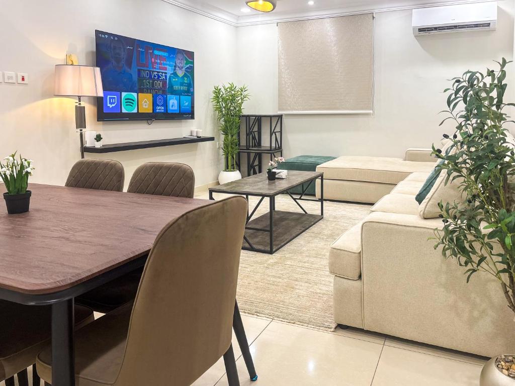 a living room with a table and a couch at Nasaem Al Naseem in Medina