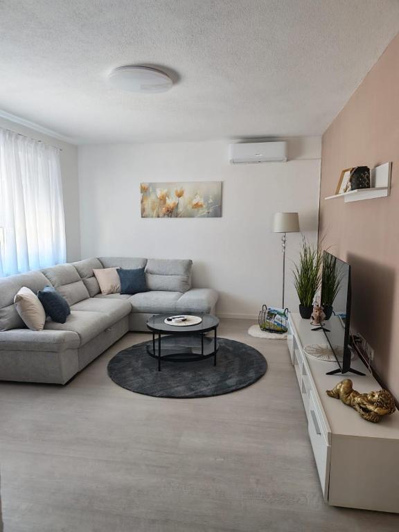 a living room with a couch and a table at Apartman Matej in Gospić