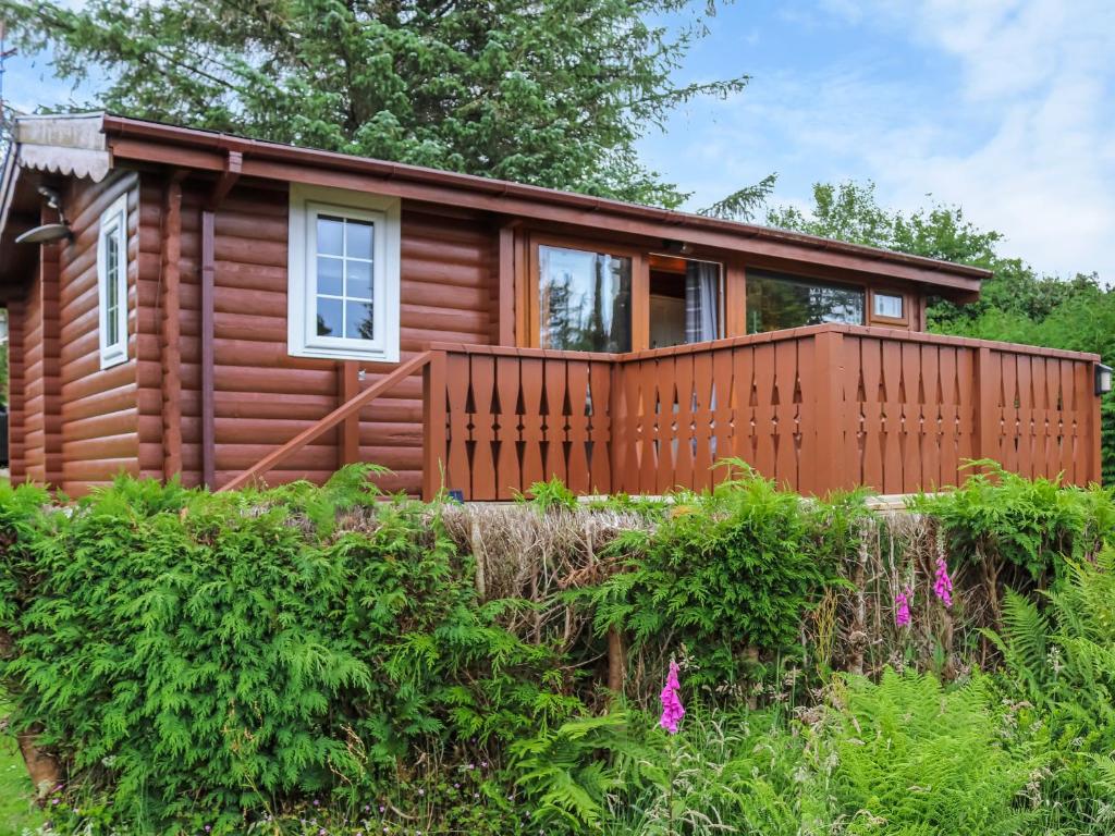 a log cabin with a wooden fence at Barken in Trawsfynydd
