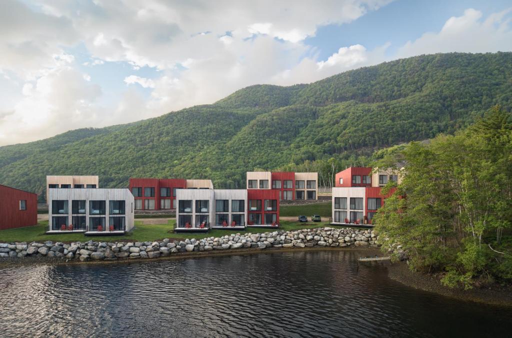 a group of buildings next to a body of water at Cormorant Rock Chalets in Ingonish Beach